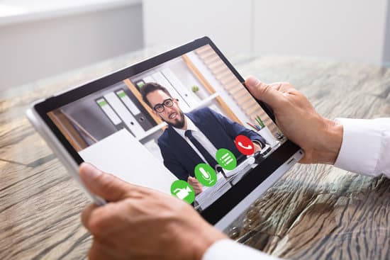Businessman Video Conferencing With Co-worker On Tablet