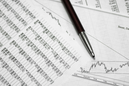 pen on paper with the price quotes and charts the dynamics of their change and coins