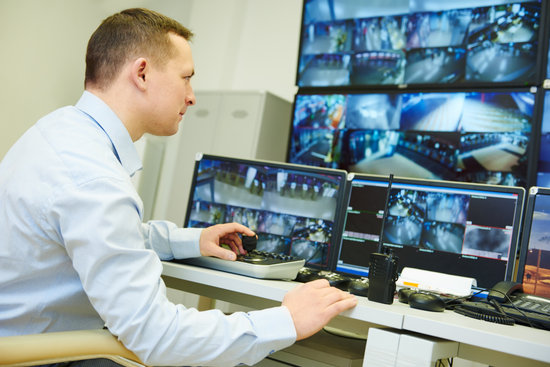 security guard officer watching video monitoring surveillance security system